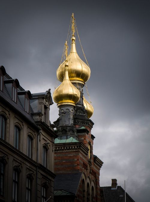 Golden onion-shaped domes on top of a church in Copenhagen, Denmark.