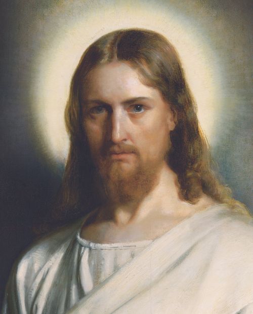 A portrait of Christ in white robes against a soft background of neutral colors, with light around His head.