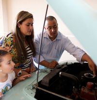 family looking at automobile engine