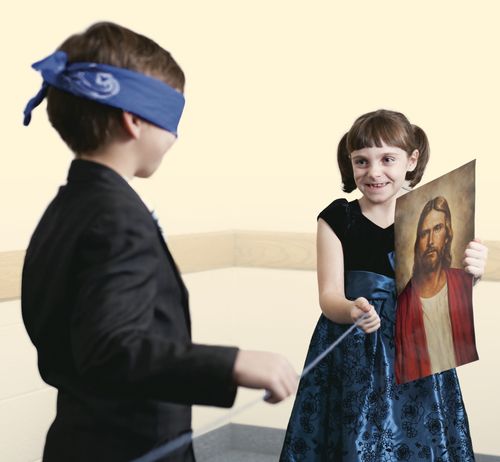 blindfolded boy following a string