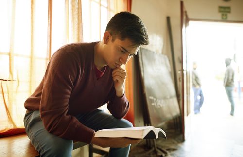 young man reading scriptures