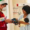 young man giving blanket for newborn