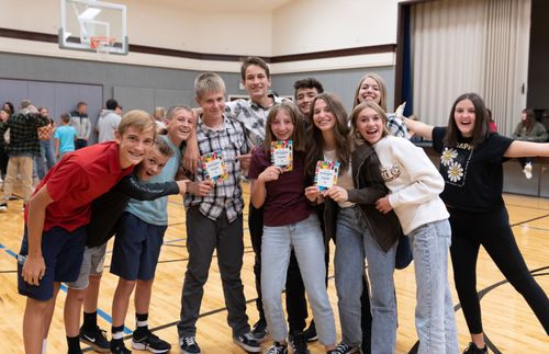 group of youth, with some holding guidebook