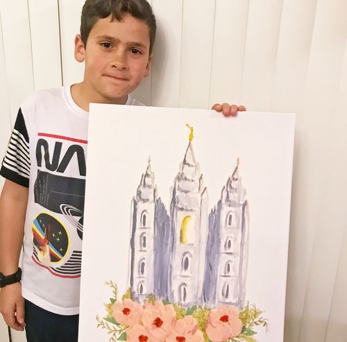 boy holding drawing of Salt Lake Temple