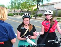 sister missionaries sharing the Book of Mormon with woman