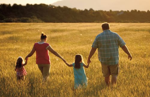 Family walking in a field.