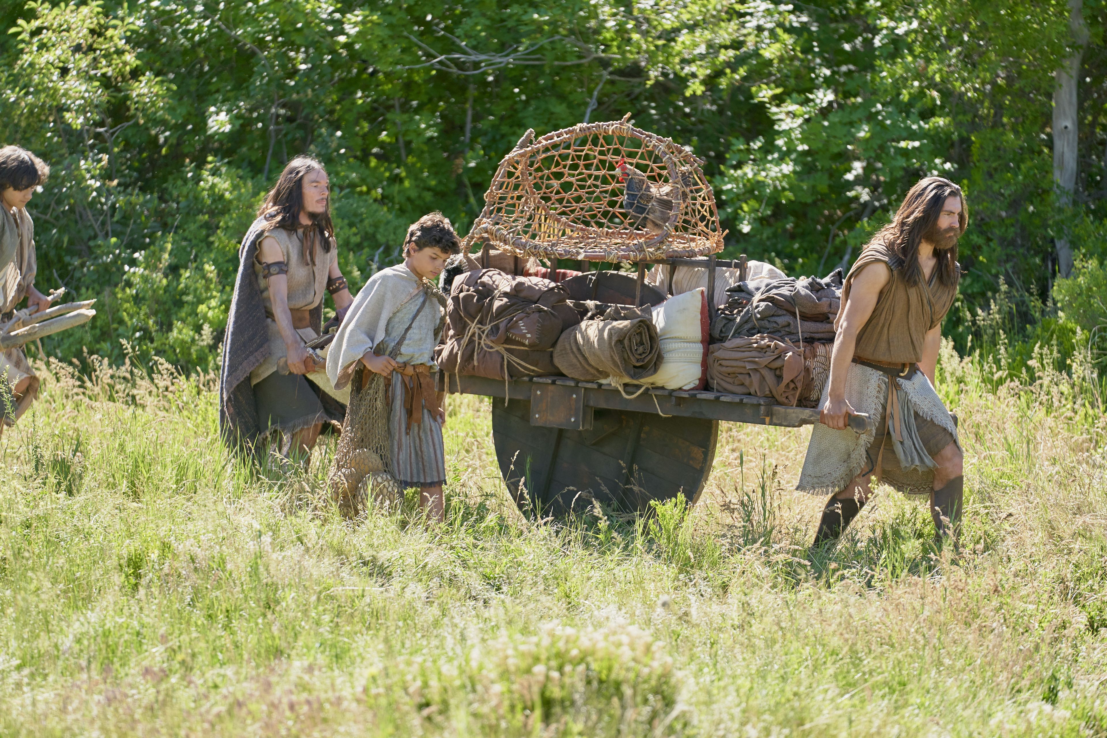 Nephi, Joseph, and Sam moving a cart of their belongings as they flee the Lamanites.