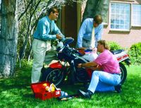 men working on motorcycle