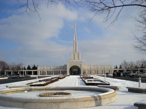 The Toronto Ontario Temple entrance, with the grounds and temple covered in snow.