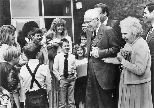 President and Sister Ezra Taft Benson in crowd of children