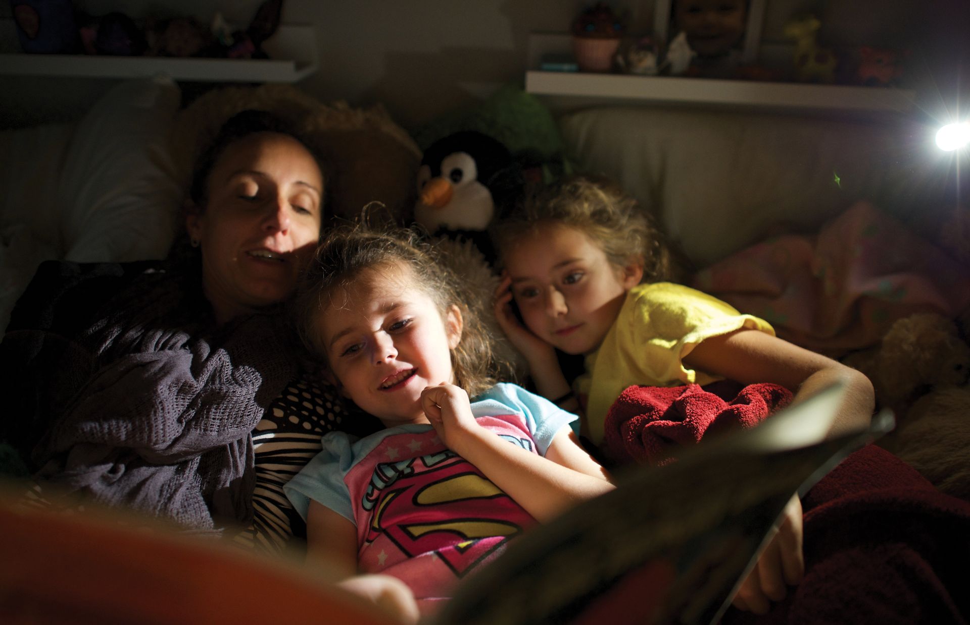 Tiffany Rinne, here reading a scripture story to daughters Sólia and Aila, says members of her family are the only Latter-day Saints most of their nonmember friends know.