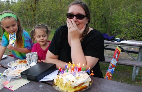 woman and children with birthday cake