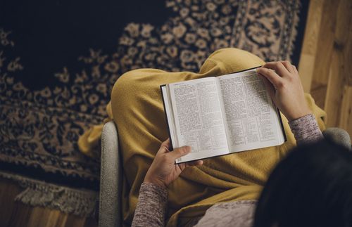 Scriptures open on a woman’s lap
