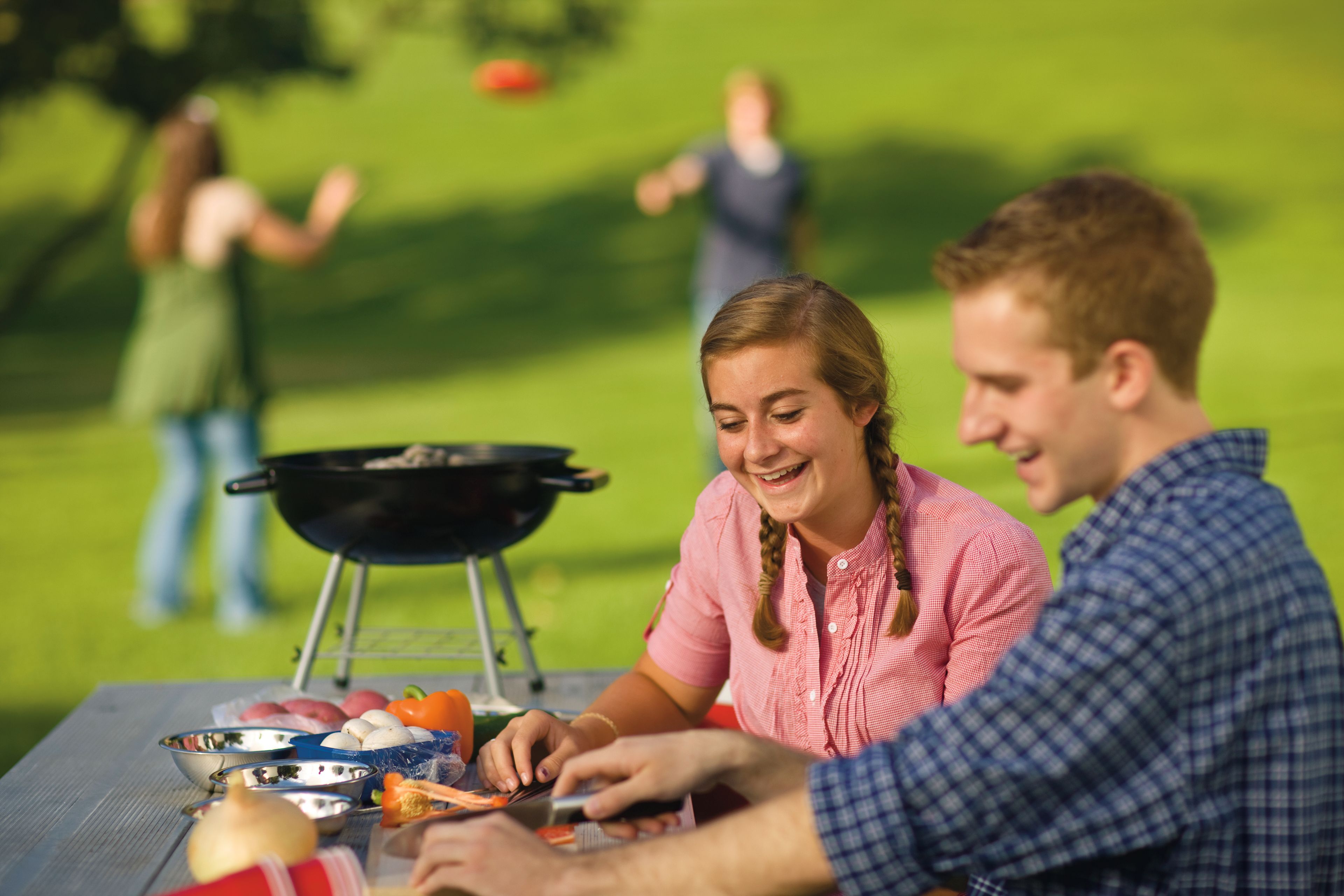 A young couple goes on a date at a barbecue.