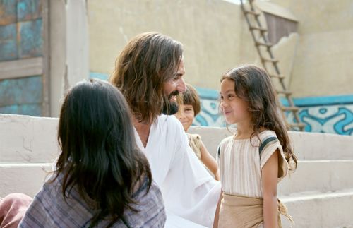Jesus Christ smiling at the children around Him