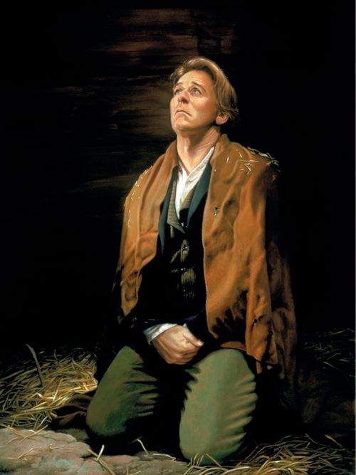 Joseph Smith Jr. kneeling amongst dirt and straw and praying