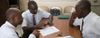 men sitting in Church meeting