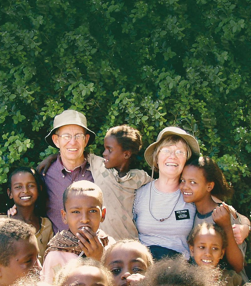 A senior missionary couple with a group of children from Ethiopia.