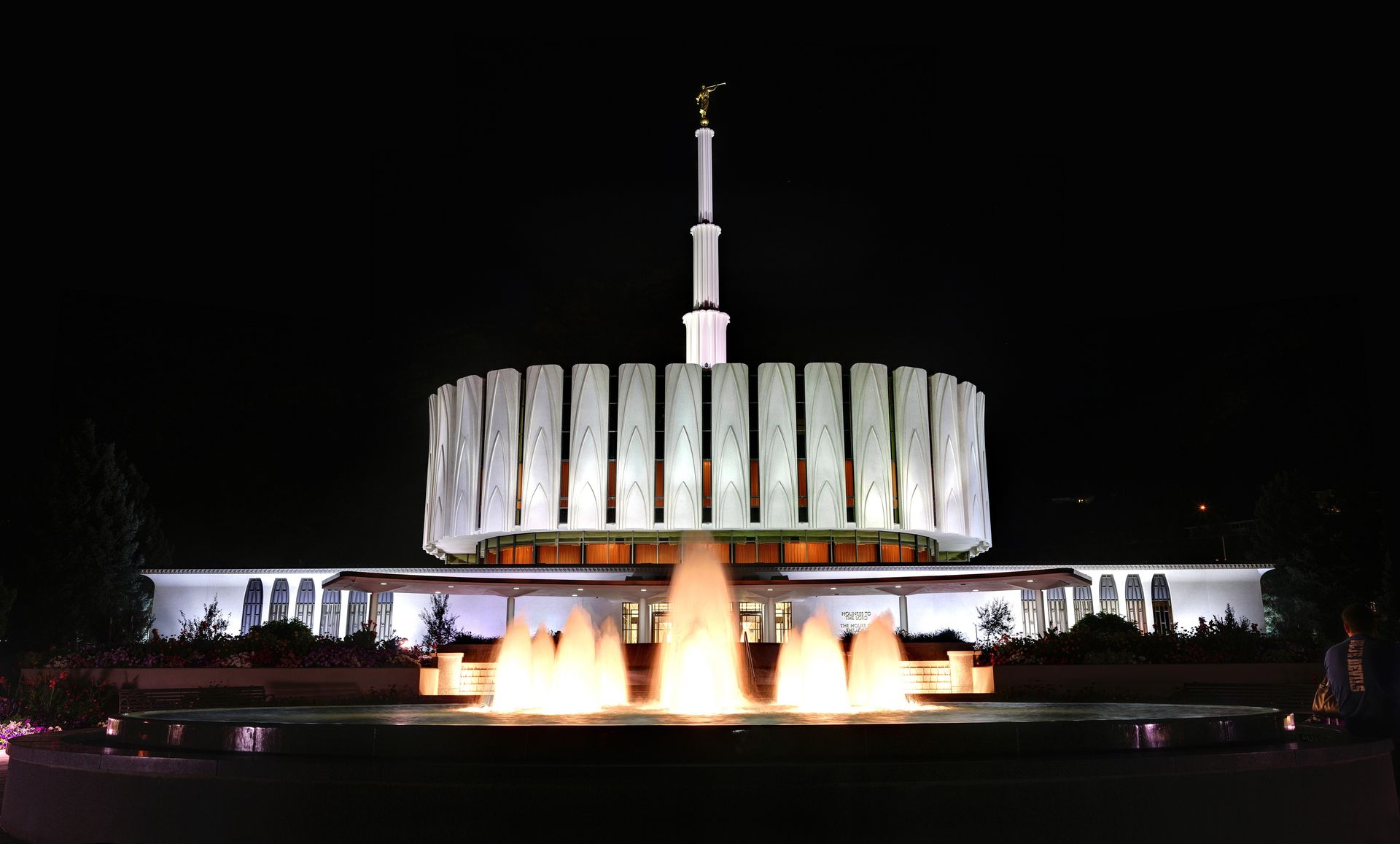 The Provo Utah Temple in the evening, including the fountain and entrance.