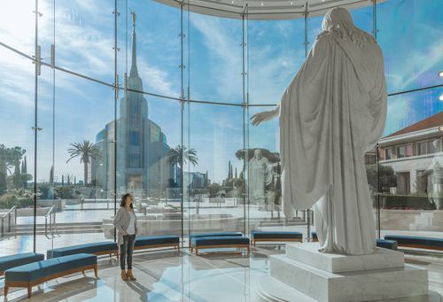 young woman looking at Christus statue near Rome Italy Temple