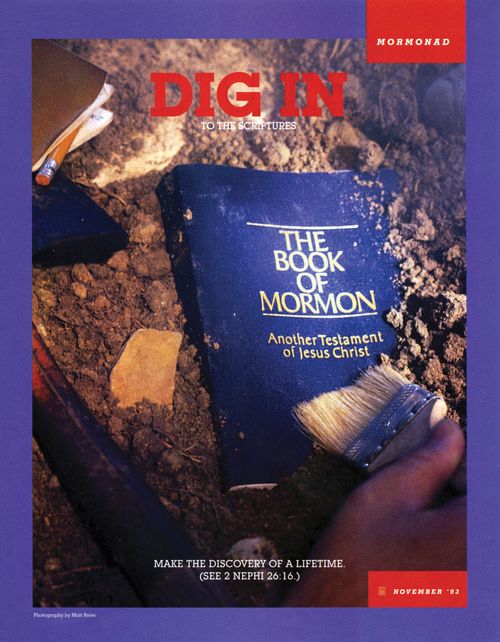 A conceptual photograph of a hand excavating a copy of the Book of Mormon, paired with the words “Dig In to the Scriptures.”