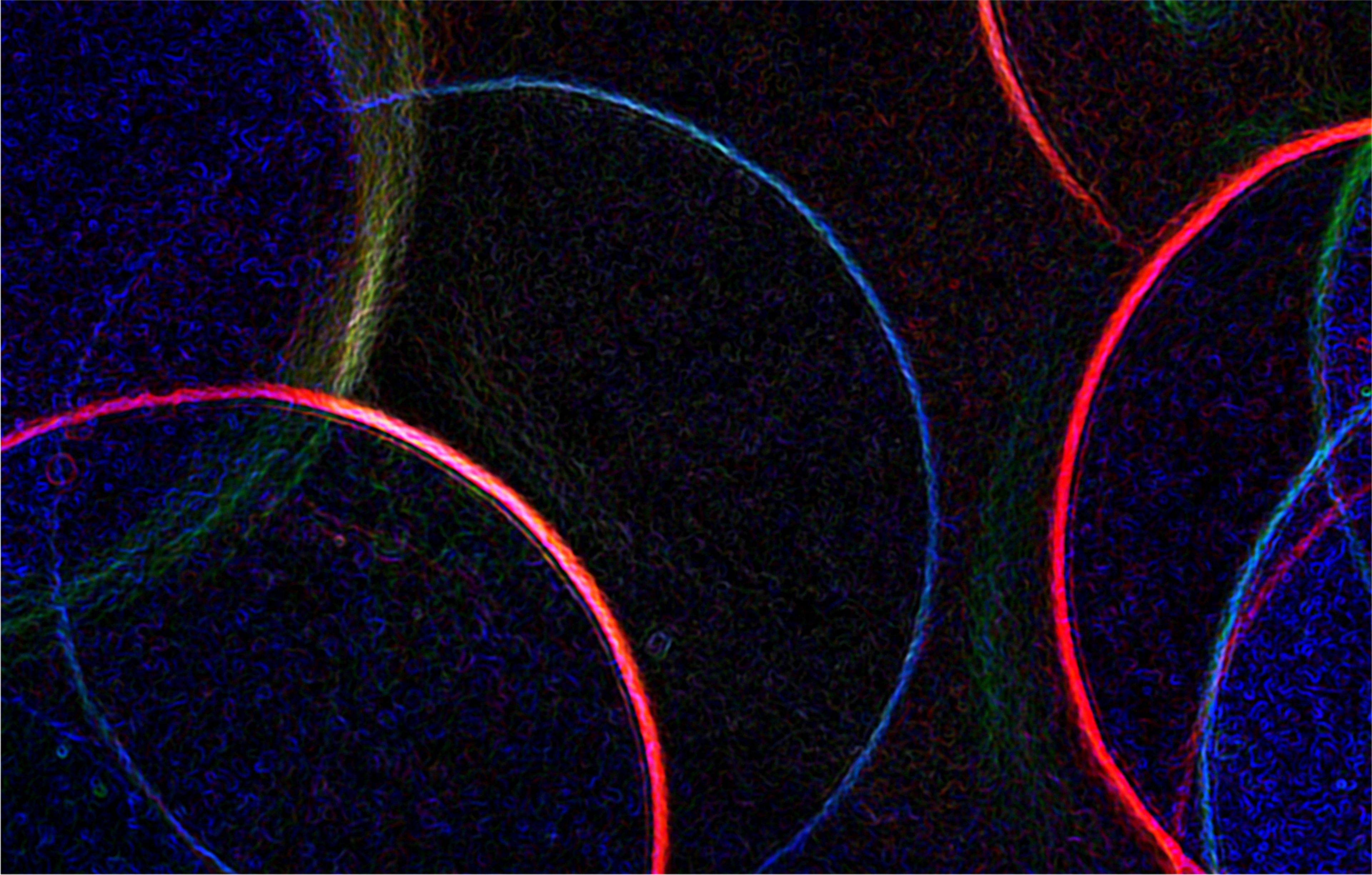 Lit rings in different colors with a dark background.