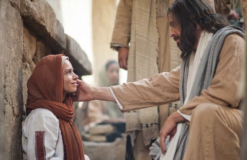 Jesus reaching out to comfort a woman