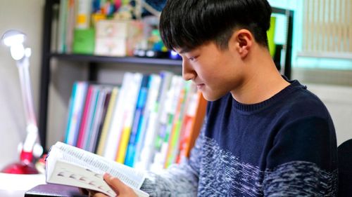 young man studying his scriptures