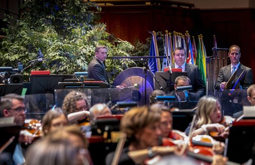 Gong player with orchestra