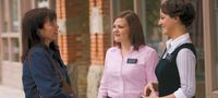 two sister missionaries talking to woman