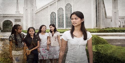 A group of young women standing in front of a temple.
