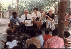 missionary couple teaching group of people