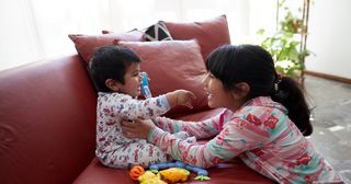 young girl playing with baby