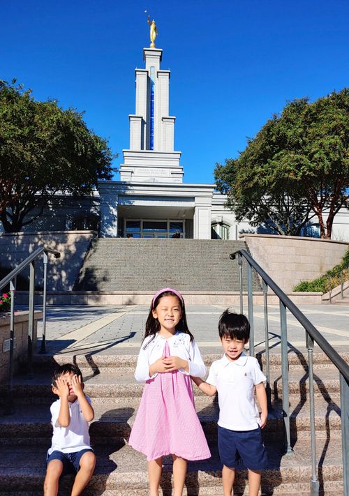 Three children on stairs in front of the San Antonio temple