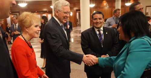 Elder D. Todd Christofferson shaking hands with woman at Conference Center