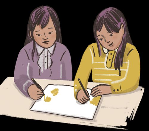 Two girls drawing on a piece of paper