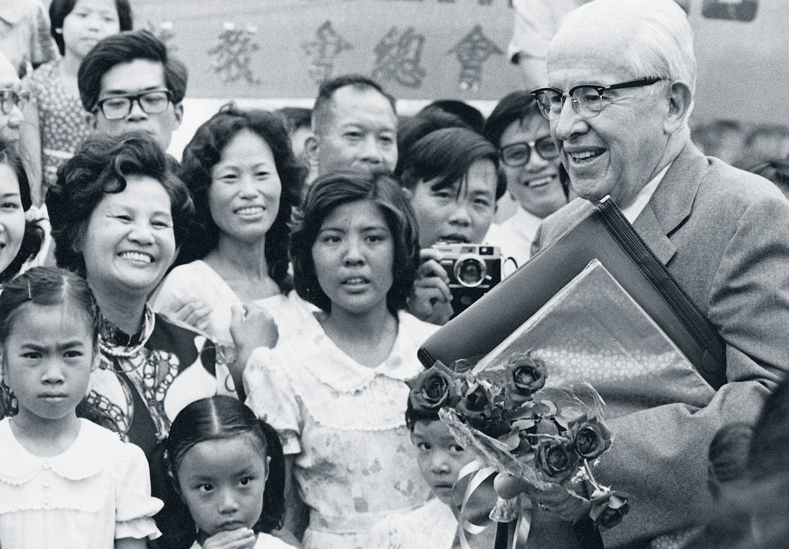 President Benson standing with members in Taiwan, around 1980.
