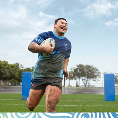 young man playing rugby