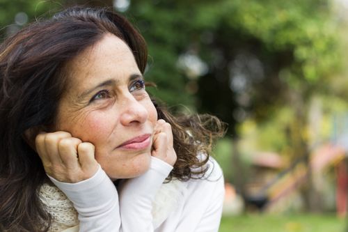 woman resting her head in her hands