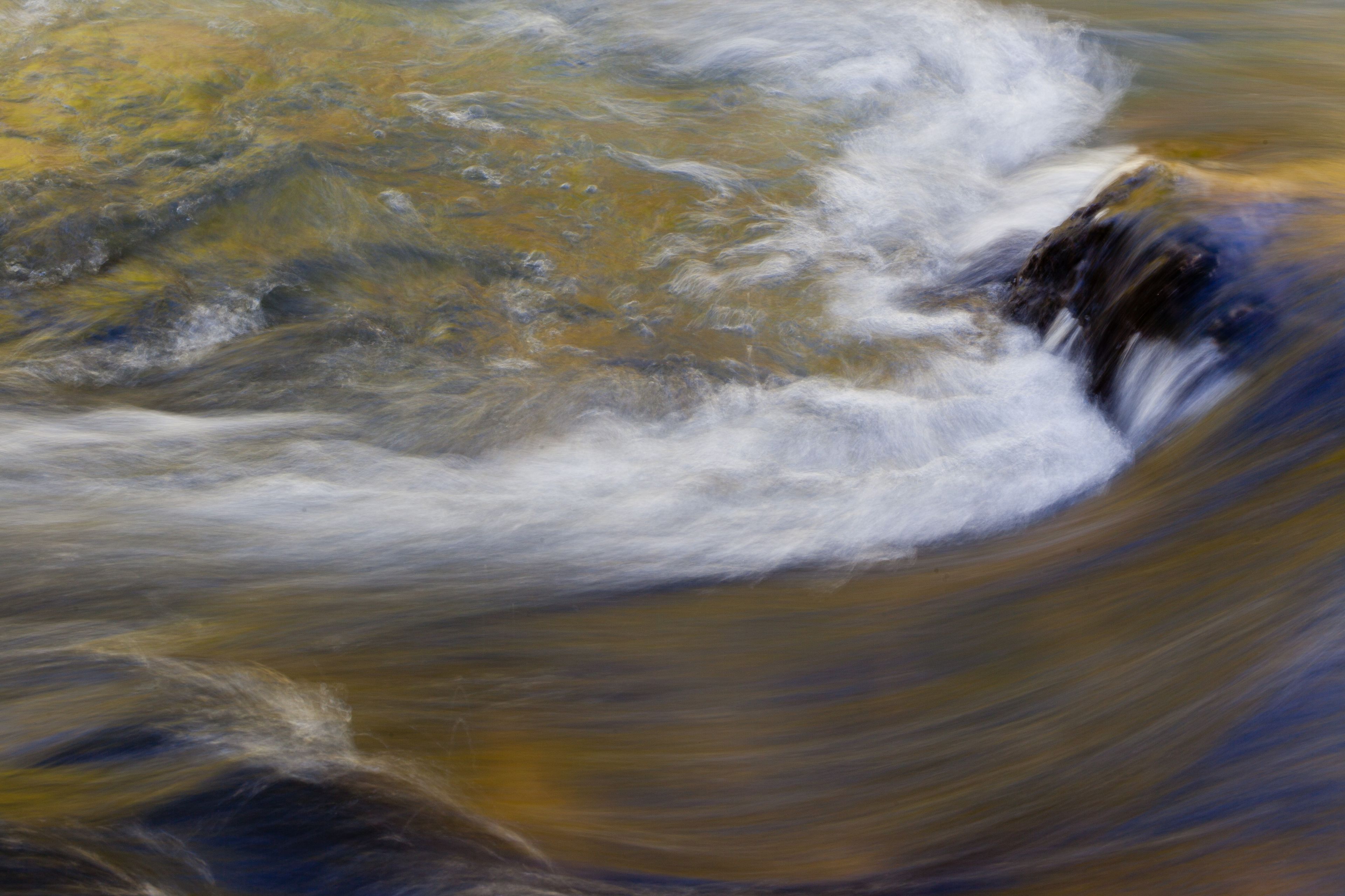 A close-up of waves crashing down in a river.