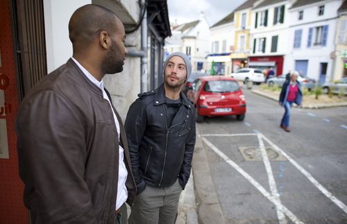 Cayo and Anthony standing on the sidewalk