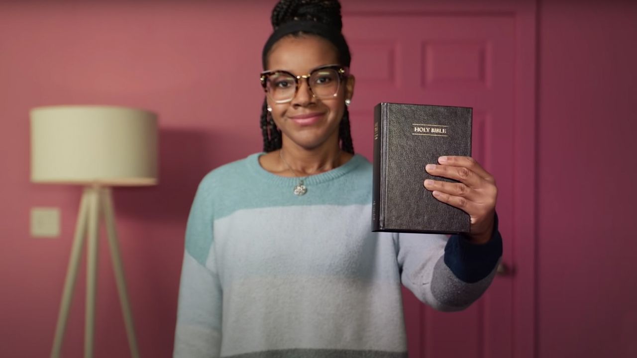 A woman holding up a Bible