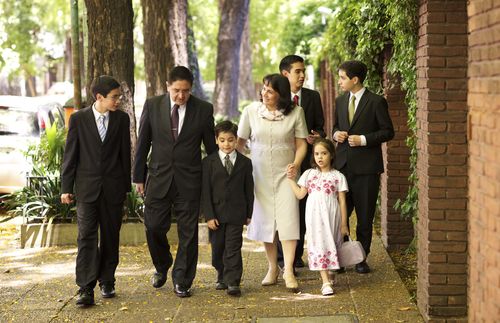 family walking down a sidewalk