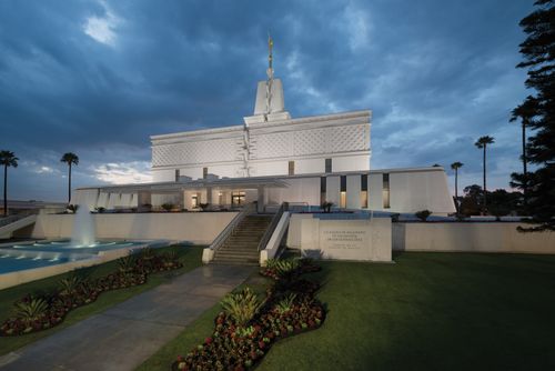 A front view of the Mexico City Mexico Temple just after sunset, with blue clouds overhead.