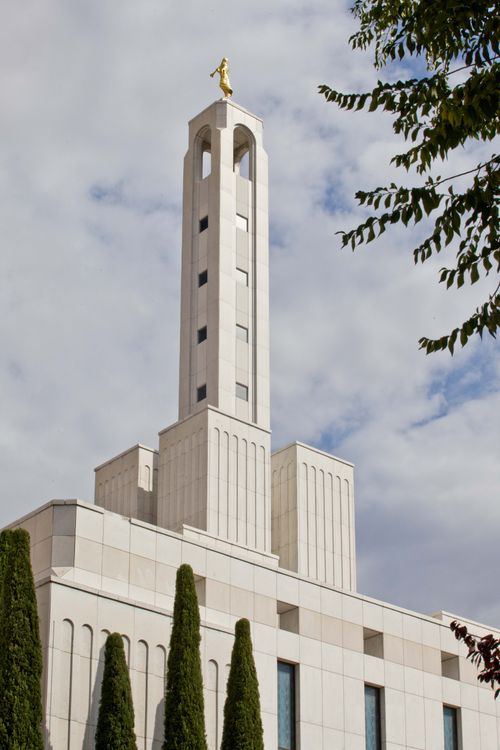 The spire tower with the angel Moroni statue on top of the Madrid Spain Temple, during the daytime.