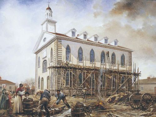 The Kirtland Temple with scaffolding on one side. Men and women are mixing plaster to apply over the bricks of the temple.