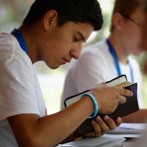 young man with scriptures at FSY conference