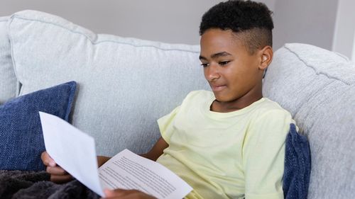 young man reading paper