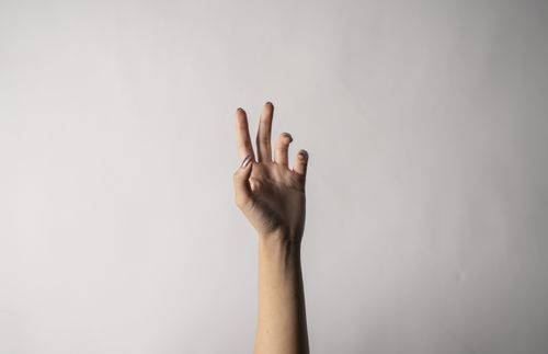 hand reaching upwards against white background