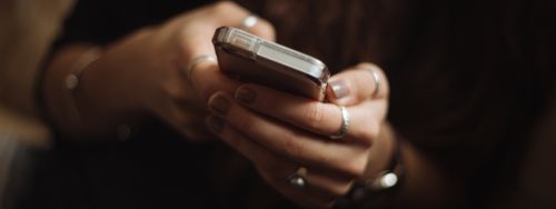 woman holding cell phone